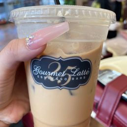 a hand holding a cup of iced coffee a hand holding a cup of iced coffee