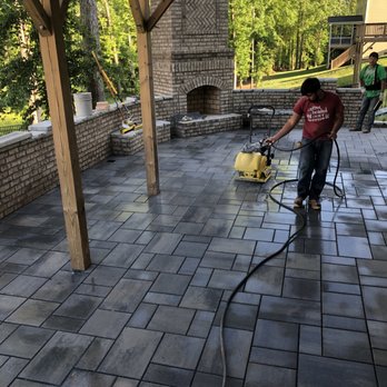 Sunset Hardscaping - a man using a pressurer on a patio - Masonry/Concrete Near Me Sunset Hardscaping - a man using a pressurer on a patio - Masonry/Concrete Near Me