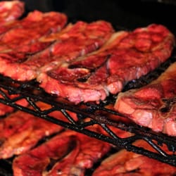 Paul's Market - Big pork steaks smoking in Ole Hickory at Paul's Market