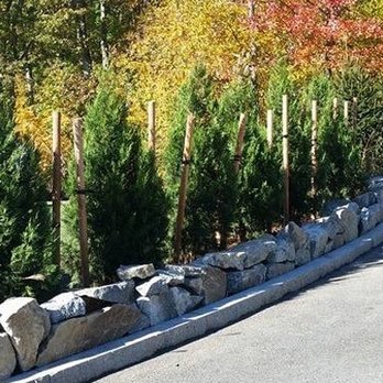 NRI Landscaping - a stone retaining along a road - Lawn Services Near Me - Cumberland, Rhode Island NRI Landscaping - a stone retaining along a road - Lawn Services Near Me - Cumberland, Rhode Island