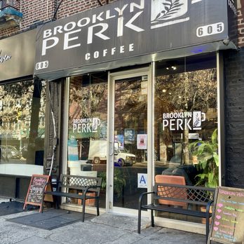 Brooklyn Perk - Exterior - Brooklyn Perk coffee shop's storefront features large glass windows, outdoor seating with benches, and signage displaying the name and logo. - Coffee & Tea Near Me - Brooklyn, New York