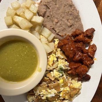 Chelis Cafe - Migas, potatoes, refried beans and asado de puerco and green salsa - Mexican Near Me - Palacios, Texas