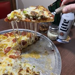 Lorenzo’s Corner Pizza & Pub - Half supreme and other half pepperoni and banana peppers. Look at that cheese pull!