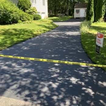 Accurate Sealcoating - a driveway with a caution tape - General Contractors Near Me - Windham, New Hampshire