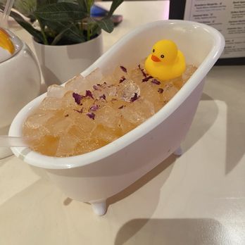 Holey Moley - Rub a Dub in the Tub Drink - a gin and Prosecco based cocktail served in a bath tub with a mini rubber Ricky and flower petals - Mini Golf Near Me - Houston, Texas Holey Moley - Rub a Dub in the Tub Drink - a gin and Prosecco based cocktail served in a bath tub with a mini rubber Ricky and flower petals - Mini Golf Near Me - Houston, Texas