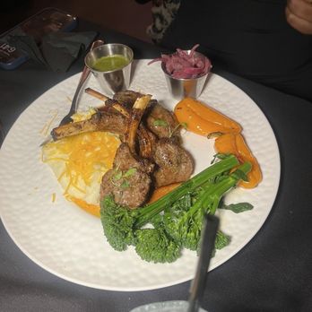 Deluxe Fun Dining - The Deluxe Lamb Chop came with broccolini and mashed potatoes. The lamb was cooked medium-well, tender, and juicy. - Bars Near Me - Charlotte, North Carolina