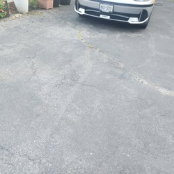Rdm Construction Companies - weeds are already coming through the asphalt.