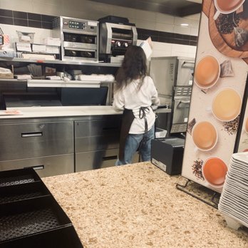 Dunkin' -  a woman preparing food in a commercial kitchen - Donuts Near Me - Old Bridge, New Jersey