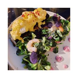 Eggs Benedict with lobster Hollandaise sauce with shrimp on top of a charcoal waffle Eggs Benedict with lobster Hollandaise sauce with shrimp on top of a charcoal waffle
