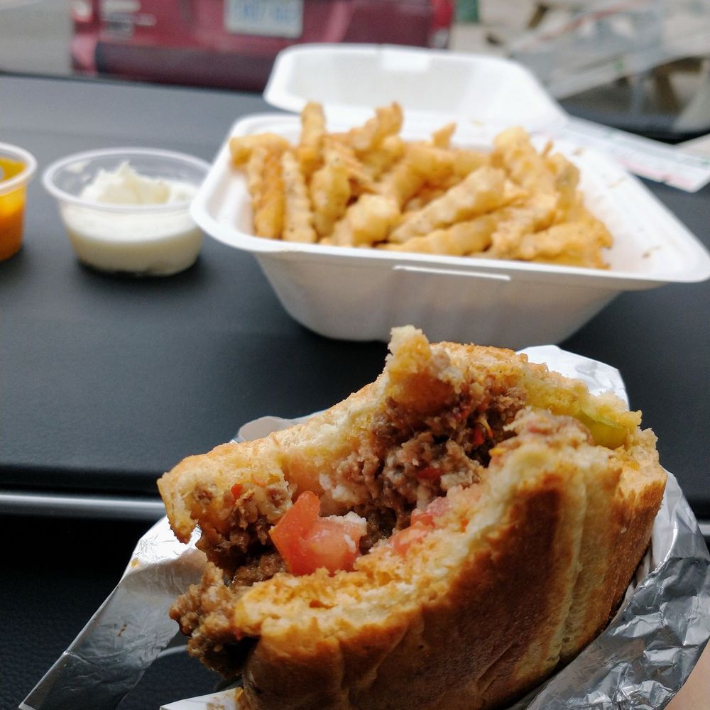 Chef Harwash - a person holding a sandwich and french fries - Mediterranean Near Me - Toronto, Ontario