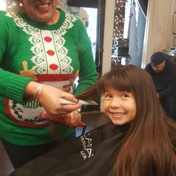 Envy Beauty Studio - Flat ironing her hair after hair cut - Hair Salons Near Me - Long Beach, California