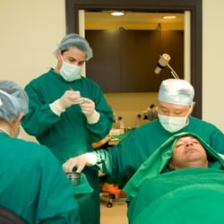 Australian Institute of Hair Restoration - Dr Andrew Kim performing FUT Hair Transplant Surgery.