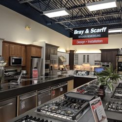 Bray & Scarff - Bray & Scarff kitchen appliance showroom floor with dishwashers, cooktops, and refrigerators on display