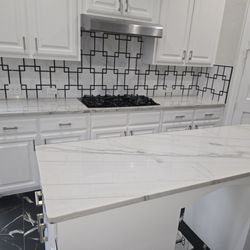 Jay the Builder - Kitchen remodel and design with quartzite countertops, marble backsplash, black marble look porcelain tiles.