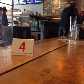 Kluddes Kitchen + Bar - Long wooden tables with bench seats. 11 televisions. Outdoor covered patio. - Gastropubs Near Me - Redlands, California