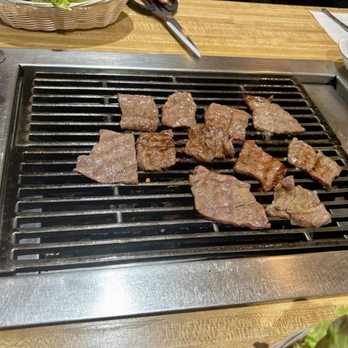 New Jang Su BBQ - Beef short rib being grilled. Be sure to ask for raw garlic, too. They might not ask you if you want this if you're not Korean! - Korean Near Me - Burlington, Massachusetts