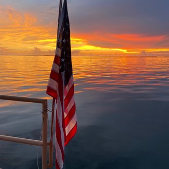 Cruisin’ Tikis Key Largo -  an american flag on a dock - Tiki Bars Near Me - Key Largo, Florida