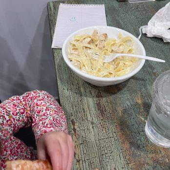 Dolcinea Pizzeria - Kids Alfredo with chicken after a few bites had already been taken. Also you can see they brought some paper for my daughter to color on. - Pizza Near Me - Virginia Beach, Virginia