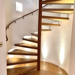 Hide and Stitch - Handrail and column covered in tan leather on-site in London property.