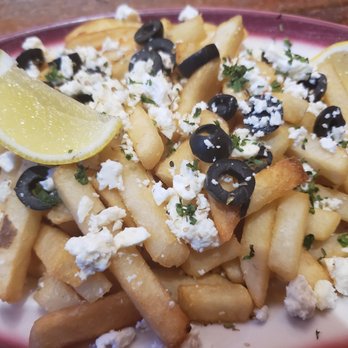 Loaded - a plate of french fries topped with feta cheese and olives - Bars Near Me - Williston Park, New York Loaded - a plate of french fries topped with feta cheese and olives - Bars Near Me - Williston Park, New York