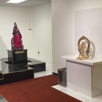 Superb Construction - a view of a room with a statue and a table - General Contractors Near Me