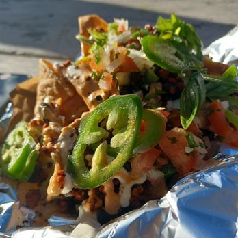 The Savage Beet - Loaded veggie nachos with soyrizo, black beans, cheeze sauce, pico, green onions and jalapeños on top. - Food Trucks Near Me