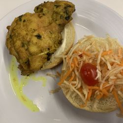 Chicken sandwich of some sort. Highlighter chicken, (that's not cheese btw), and half a slice of a baby tomato.
