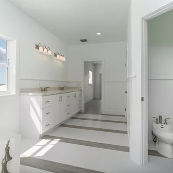 Concept Tile Kitchen & Bath - a white bathroom with a striped floor - Flooring Near Me