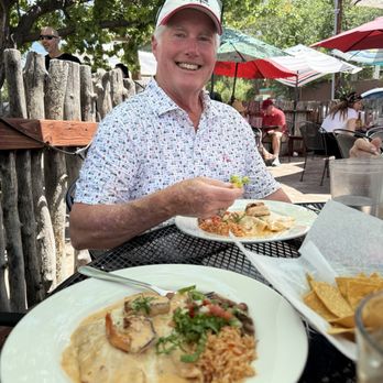 La Cueva Cafe - Seafood enchilada, and a Texan who's enjoying it immensely. - Mexican Near Me - Taos, New Mexico