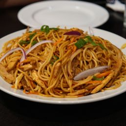 a plate of noodles on a table a plate of noodles on a table