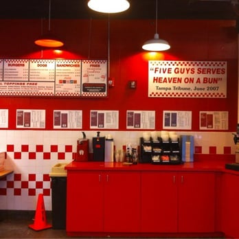 Five Guys - a man standing in a diner - Burgers Near Me - Washington, DC, District of Columbia