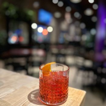 Half Sour - a drink in a glass on a table - New American Near Me - Chicago, Illinois Half Sour - a drink in a glass on a table - New American Near Me - Chicago, Illinois