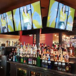 a bar with several televisions above it a bar with several televisions above it