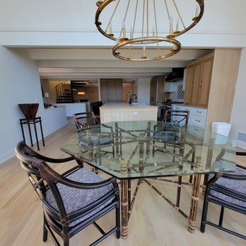 Mateo Construction - a dining room with a glass table and chairs - General Contractors Near Me Mateo Construction - a dining room with a glass table and chairs - General Contractors Near Me