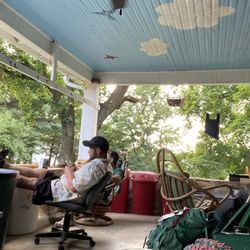 Open Arms at the Edge of Town Hostel & Inn - Lounging on the back porch after a long days hike