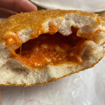 Panzarotti Tarantini Pizzeria - a hand holding a half eaten sandwich - Pizza Near Me - Camden, New Jersey Panzarotti Tarantini Pizzeria - a hand holding a half eaten sandwich - Pizza Near Me - Camden, New Jersey