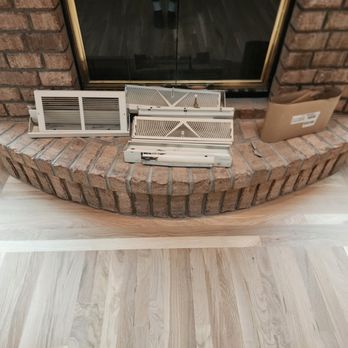 SV - a fireplace with a brick surround and a fire place - Flooring Near Me SV - a fireplace with a brick surround and a fire place - Flooring Near Me