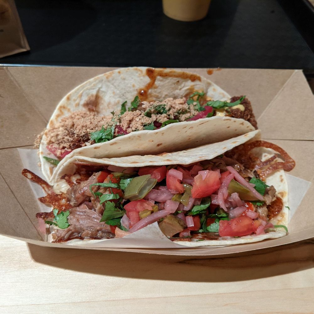 Taco Bamba Raleigh - Top: The Queen Bee (crispy chicken taco) Bottom: A Carnitas taco served "Dirty Style" - Tacos Near Me - Raleigh, North Carolina Taco Bamba Raleigh - Top: The Queen Bee (crispy chicken taco) Bottom: A Carnitas taco served "Dirty Style" - Tacos Near Me - Raleigh, North Carolina