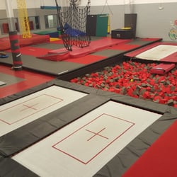 Motion Education - Dynamite Agility Center has four trampolines upstairs.Two of the upstairs trampolines are custom designed with one open end into the pit.