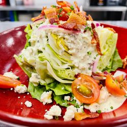 Hard Count Kitchen & Cocktails - Wedge of crisp iceberg lettuce, hickory bacon, bleu cheese crumbles, tomatoes, red onions, bleu cheese dressing