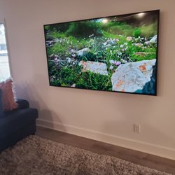 Hoz TV - 75 in mounted TV with no cords showing.