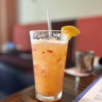 Baboush - a glass of orange juice on a table - Moroccan Near Me - Dallas, Texas Baboush - a glass of orange juice on a table - Moroccan Near Me - Dallas, Texas