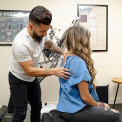 Pure Life Chiropractic - Dr. Moses examining a patient.