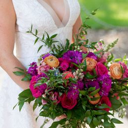 a bride holding a bouquet of flowers