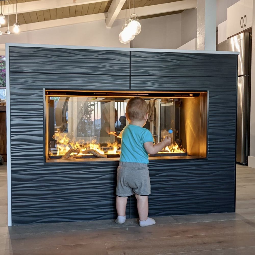 a little boy standing in front of a fireplace a little boy standing in front of a fireplace