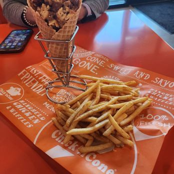 Chick'nCone - a basket of french fries on a table - Chicken Shop Near Me - Estero, Florida