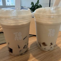 Ember milk tea with barley jelly (right) and cassia milk tea with brown sugar tapiochi (left). Both less sweet with no ice. Ember milk tea with barley jelly (right) and cassia milk tea with brown sugar tapiochi (left). Both less sweet with no ice.