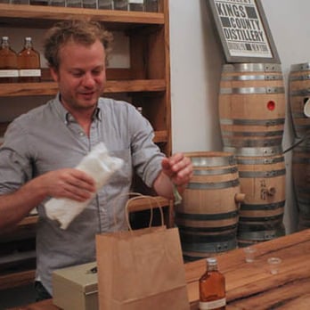 Kings County Distillery - Founder Colin Spoelman packing up some bottles after a tasting. - Distilleries Near Me - Brooklyn, New York Kings County Distillery - Founder Colin Spoelman packing up some bottles after a tasting. - Distilleries Near Me - Brooklyn, New York