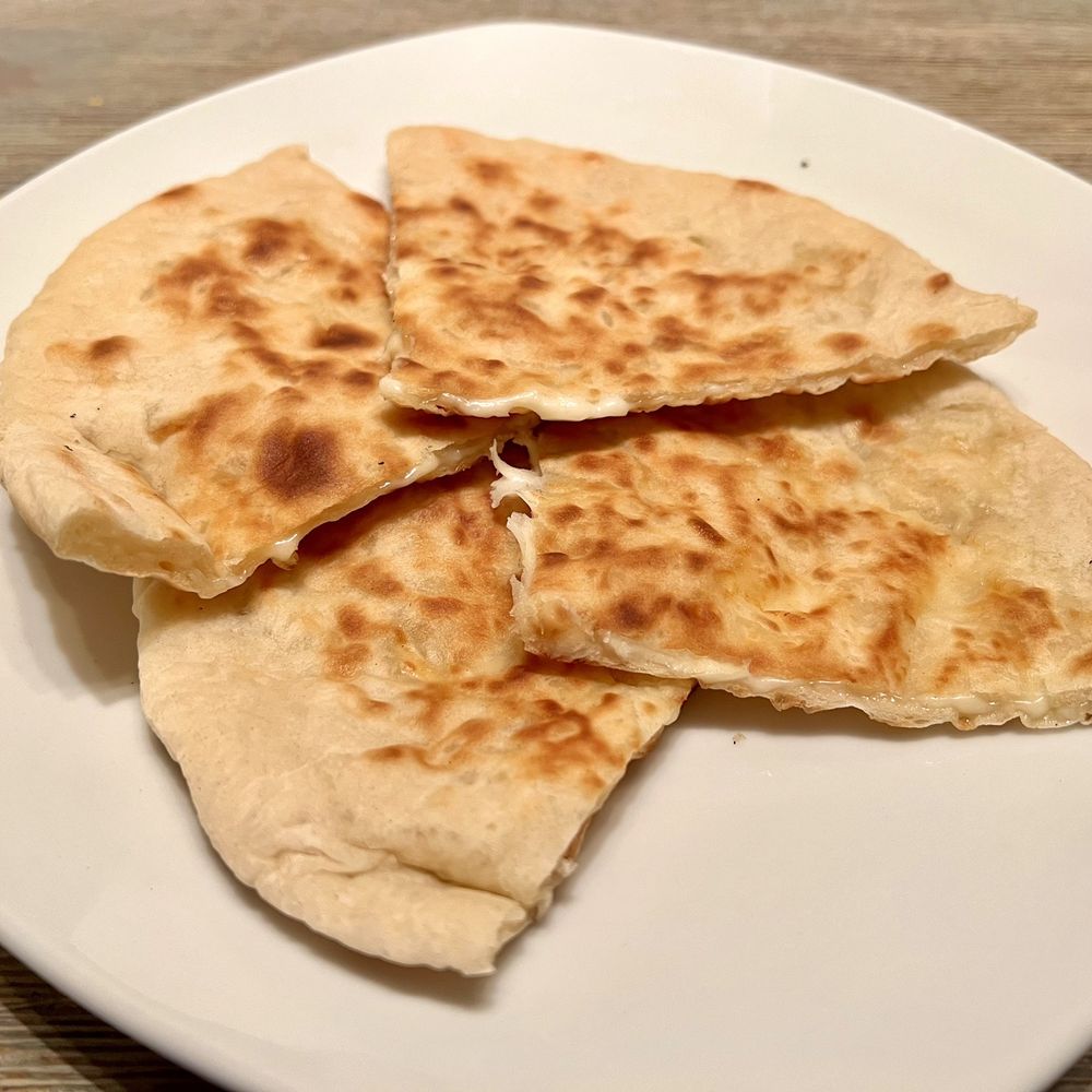 Everest Cuisine - Cheese Naan. Melted cheese is sandwiched in between the naan and while it's good, more cheese would've been better. #cheesefiend - Indian Near Me - Mission Viejo, California Everest Cuisine - Cheese Naan. Melted cheese is sandwiched in between the naan and while it's good, more cheese would've been better. #cheesefiend - Indian Near Me - Mission Viejo, California