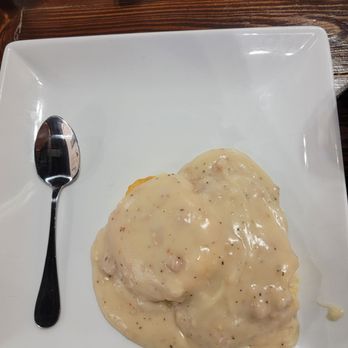 Sizzle & Brew - Biscuit and gravy with spoon - Breakfast & Brunch Near Me - Tomball, Texas Sizzle & Brew - Biscuit and gravy with spoon - Breakfast & Brunch Near Me - Tomball, Texas